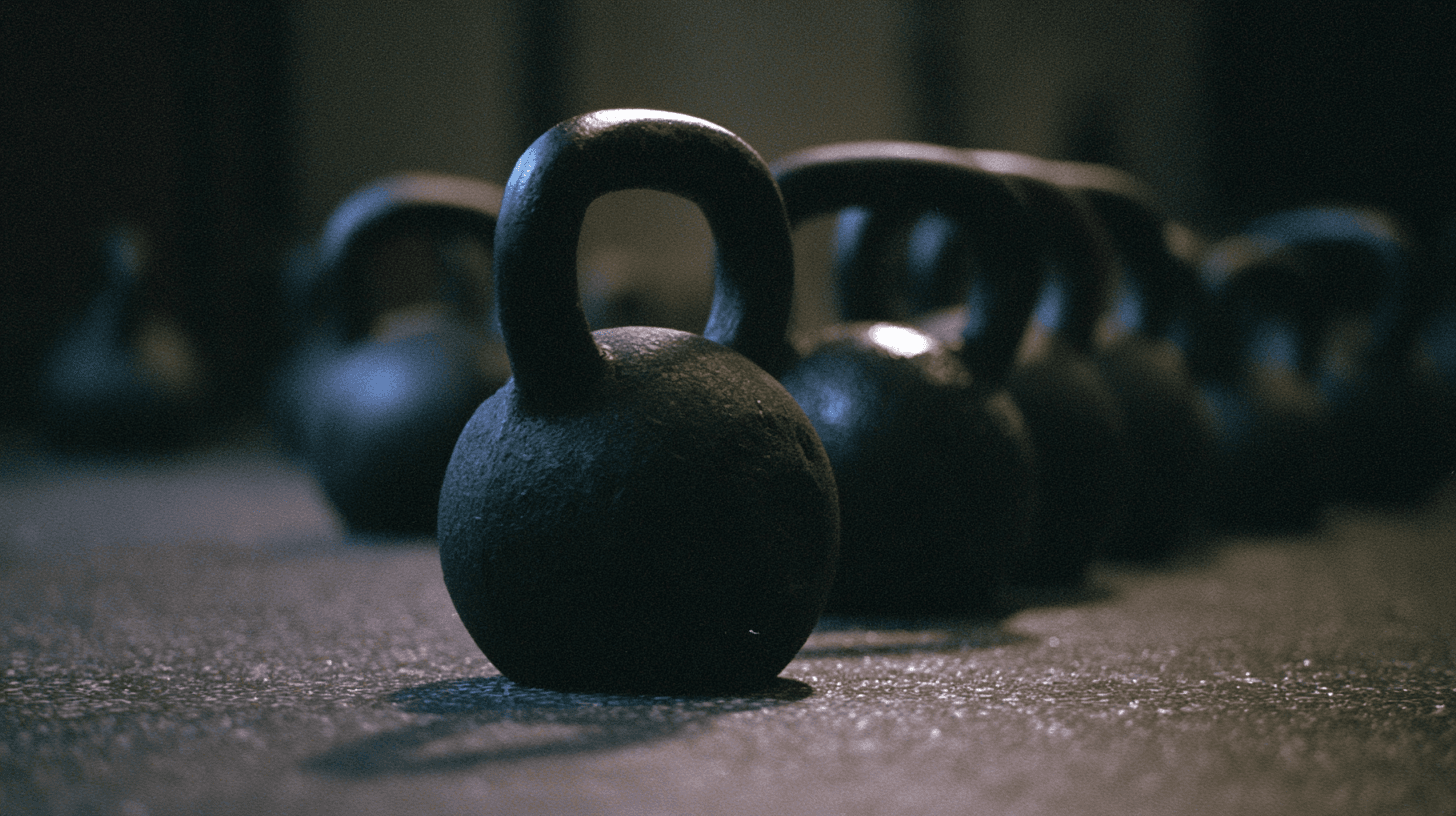 Kettlebells resting on a gym floor